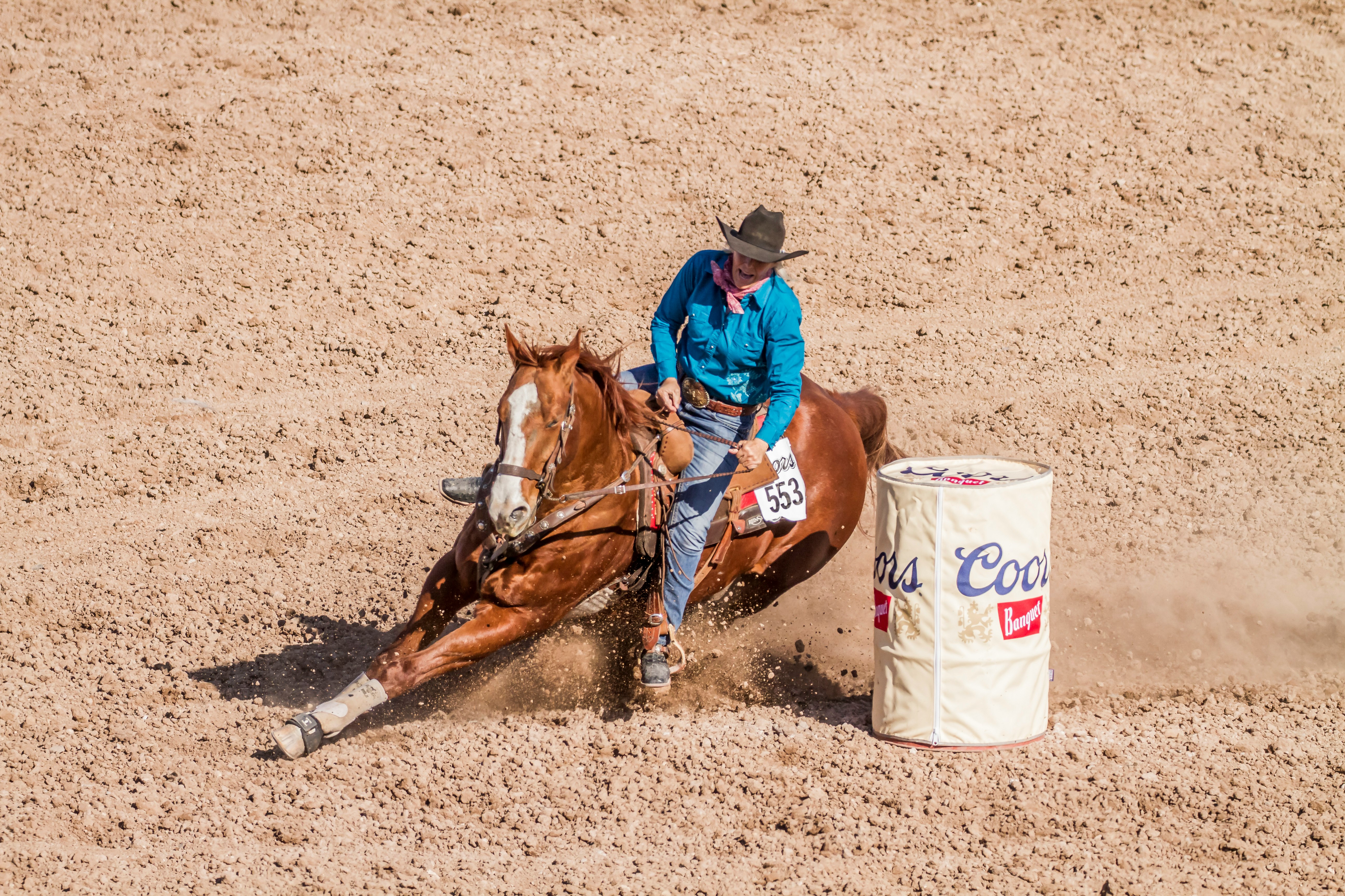 man riding on brown horse running on brown field